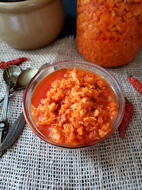 Freshly made carrot pickle served in a glass bowl.
