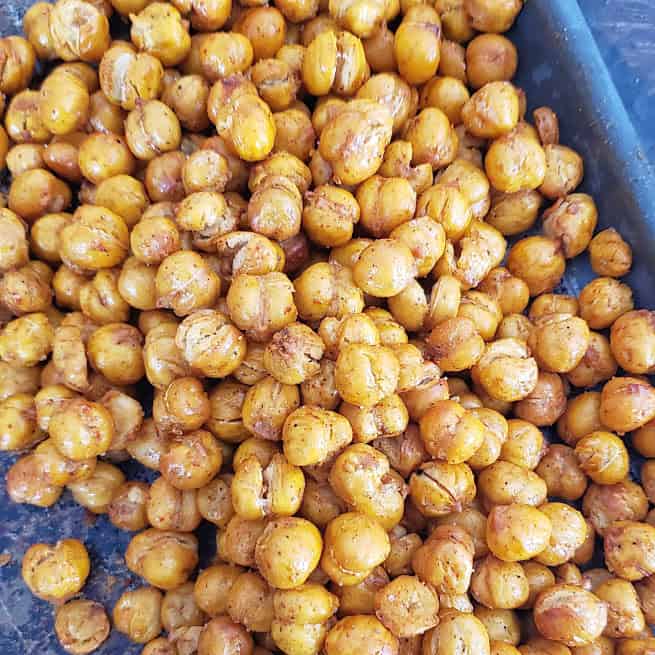A close up of dry roasted and garam masala seasoned chickpeas showing crisp texture.