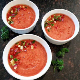 A garnished servings of Vegan Gazpacho Soup. This cold vegetable soup is summer must have.