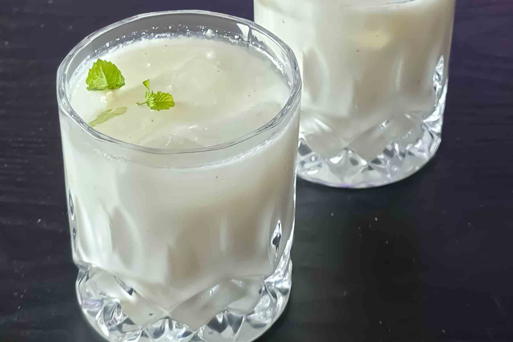 Traditional Indian yogurt drink garnished with fresh mint and roasted cumin.
