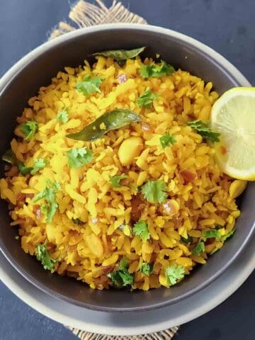 Easy Indian Poha Recipe made with flattened rice, onions, curry leaves, and turmeric.