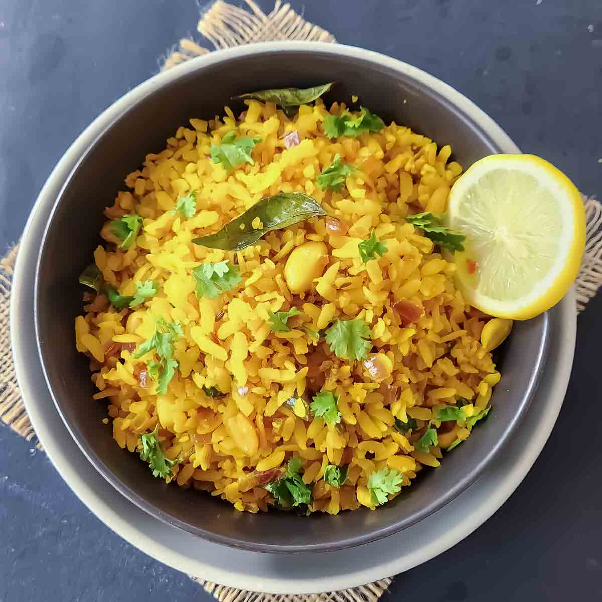 Easy Indian Poha Recipe made with flattened rice, onions, curry leaves, and turmeric.