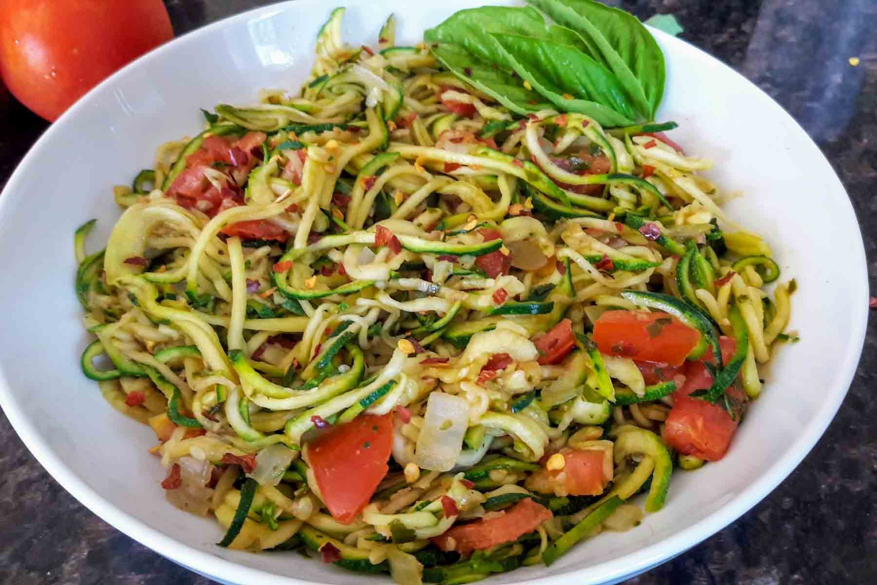 Spiralized zucchini recipe with Italian Flavors served on the dinner plate. 