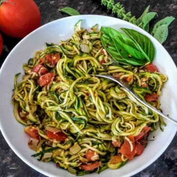 Zucchini noodles cooked with Italian seasoning for vegan, gluten-free and low carb meal.