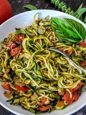 Zucchini noodles cooked with Italian seasoning for vegan, gluten-free and low carb meal.