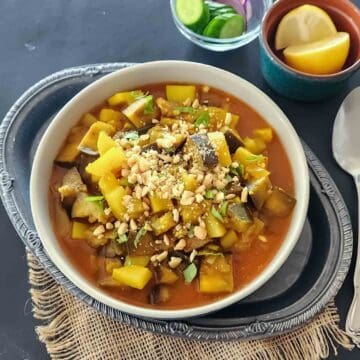 Indian Eggplant Curry combines tender eggplant and potatoes with tomatoes and aromatic Indian spices. A flavorful vegan and gluten-free Aloo Baingan recipe with Instant Pot and stovetop instructions.