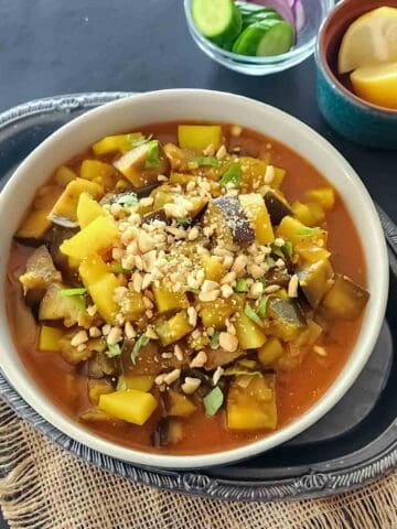 Indian Eggplant Curry combines tender eggplant and potatoes with tomatoes and aromatic Indian spices. A flavorful vegan and gluten-free Aloo Baingan recipe with Instant Pot and stovetop instructions.