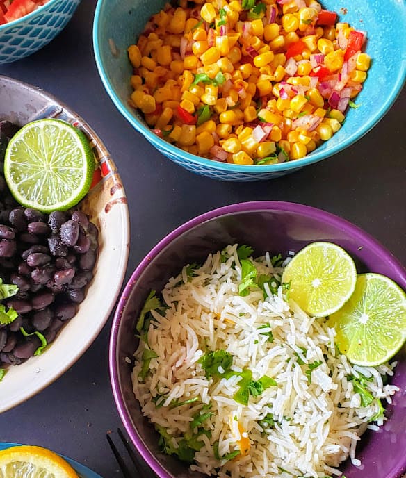 Cilantro lime rice and Mexican Corn salad bowls are part of do your own taco bar.