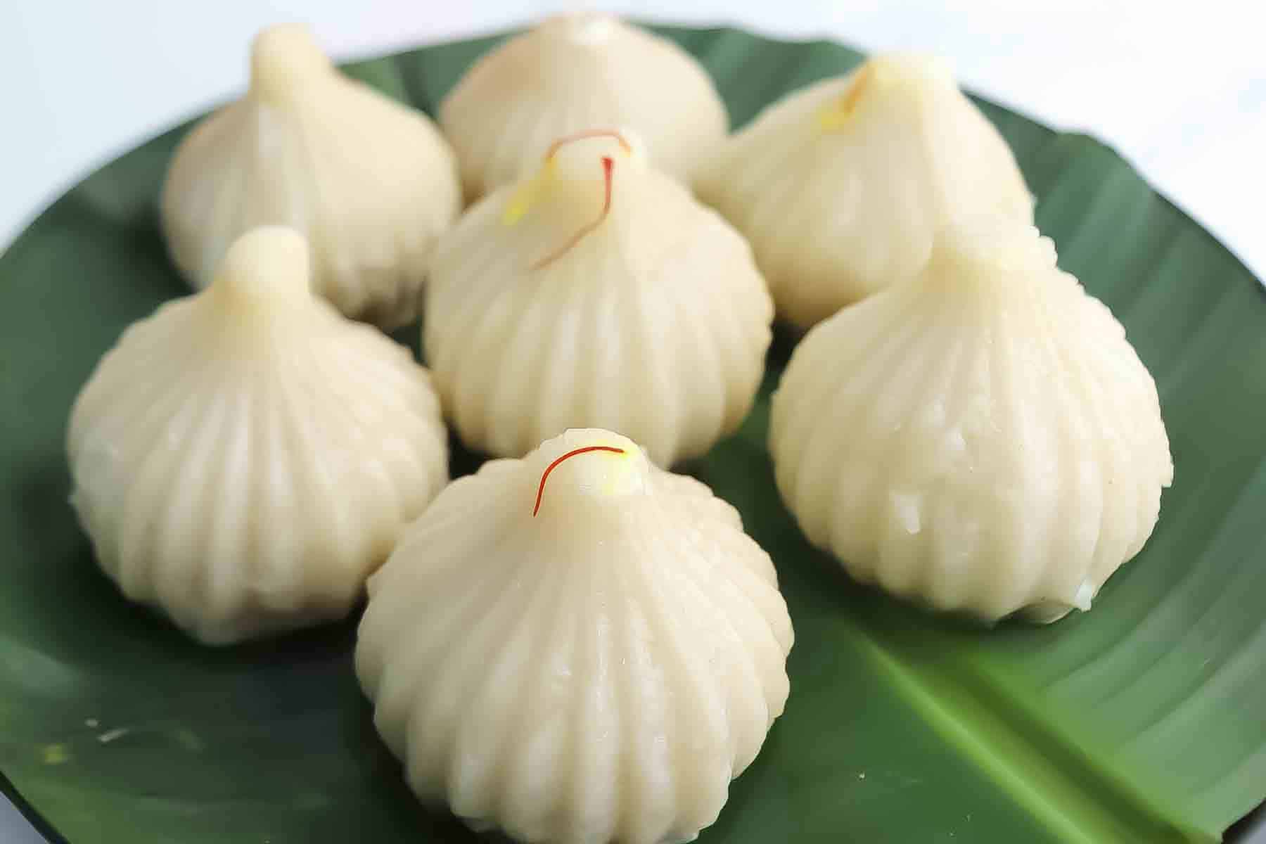 Steamed coconut jaggery modak served warm for Ganpati.
