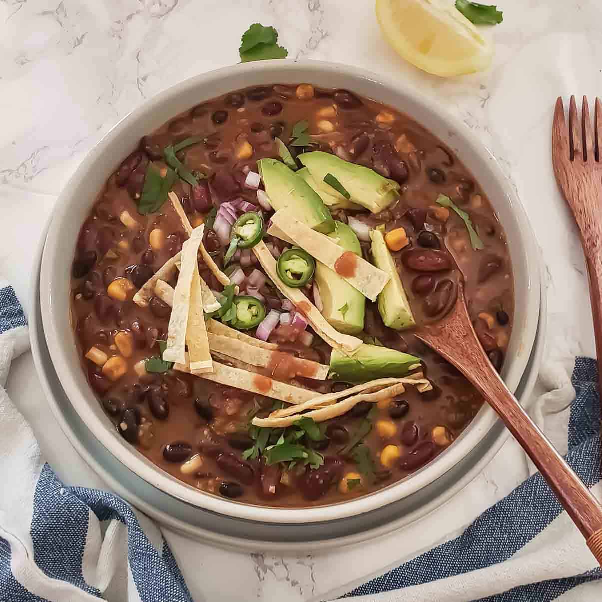 A bowl full of hearty comforting Vegetarian chili recipe with beans. This earthy comfort food makes excellent one pot meal.