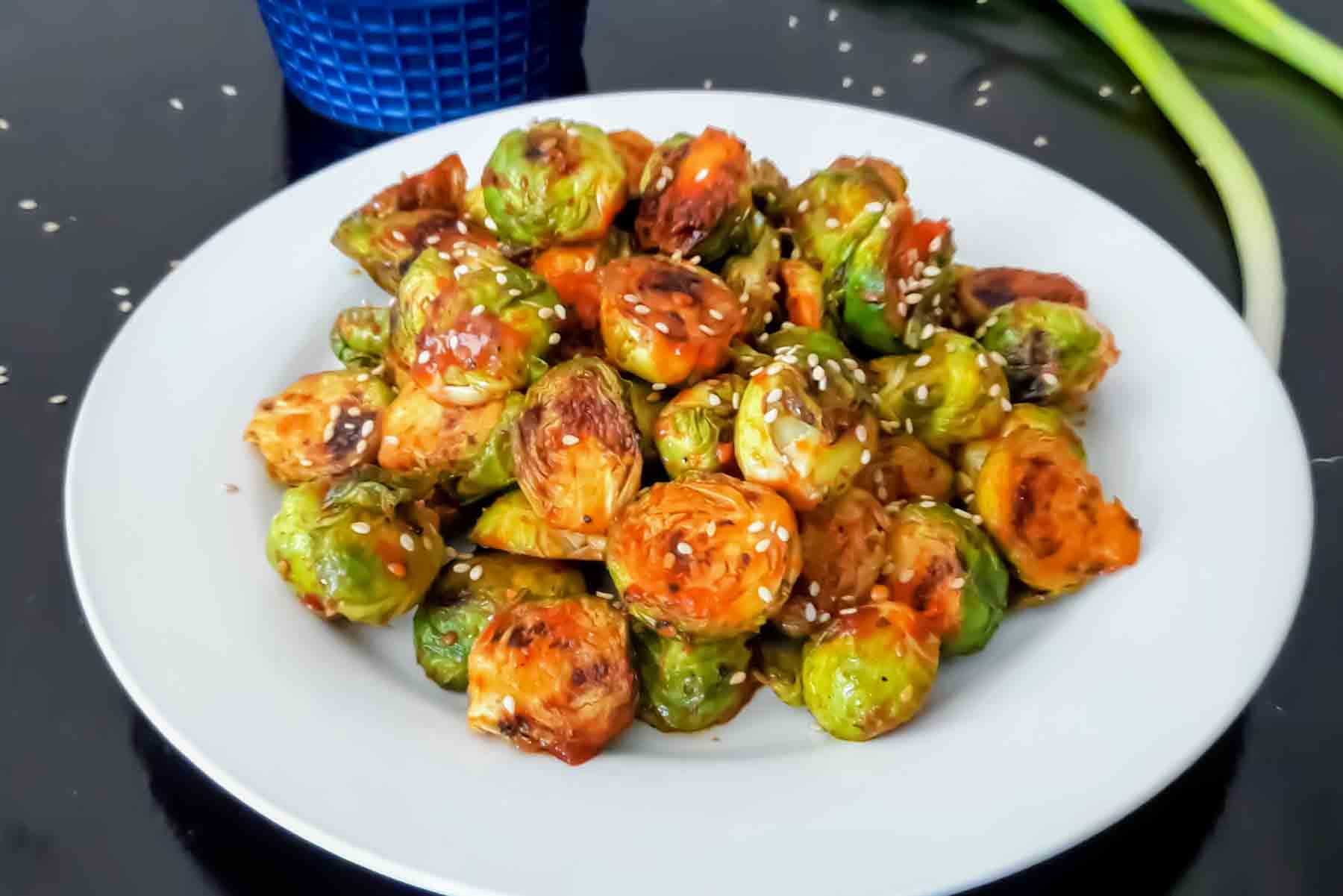 Korean-inspired gochujang Brussels sprouts with sesame seeds.