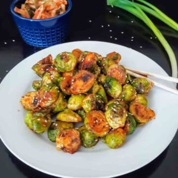 Easy gochujang Brussels sprouts side dish with sesame seeds.