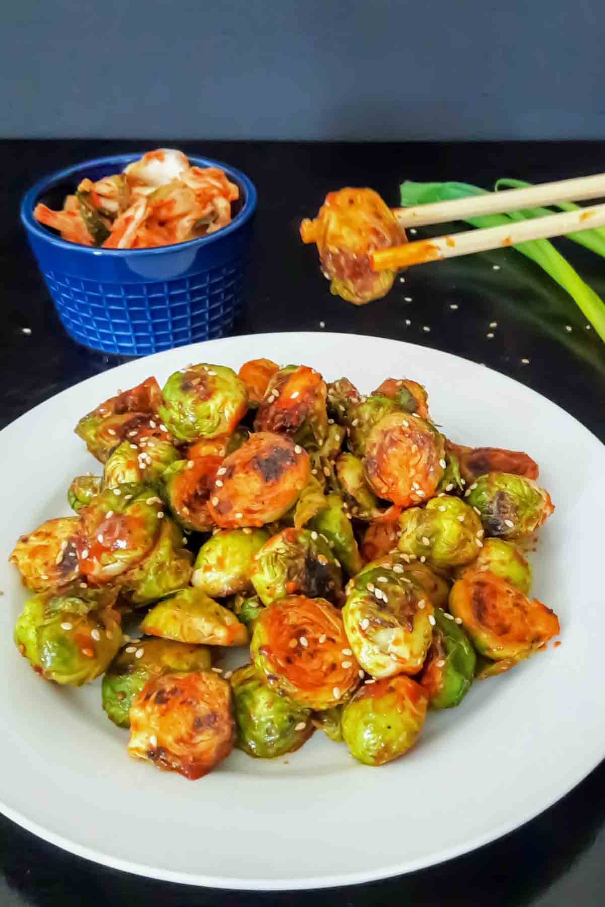 These Gochujang Brussels Sprouts are crispy, spicy, savory, and easy to make. A delicious Korean-inspired side dish made with gochujang, sesame oil, and sesame seeds.