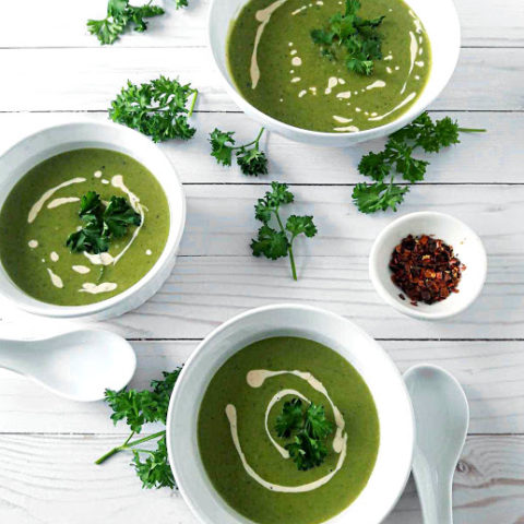 Green Pea and Mint Soup in 3 serving bowls with decorations