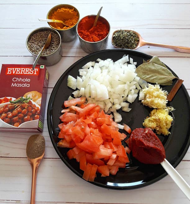 Chana Masala Ingredients and spices on black platter