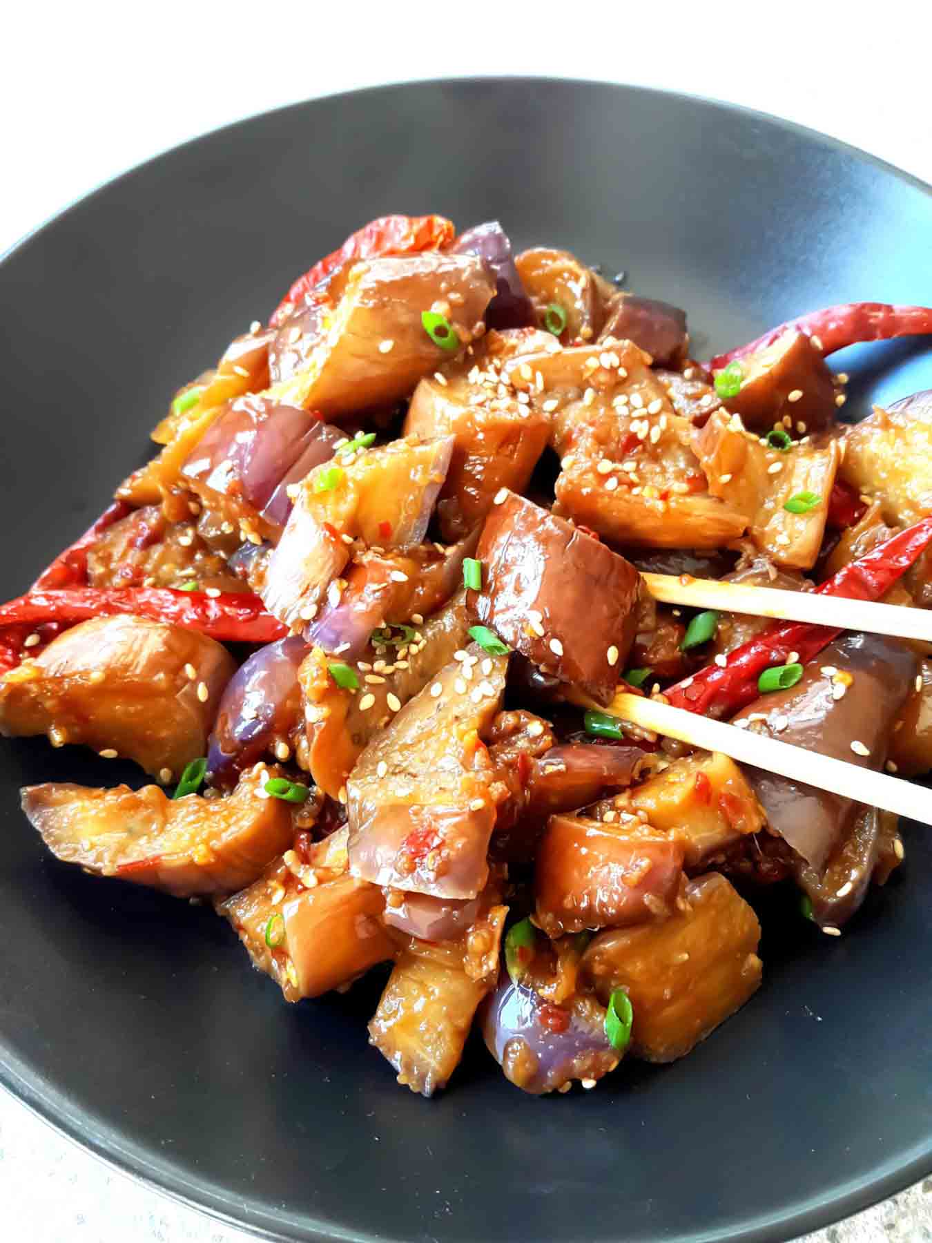 Close-up of Japanese eggplant in glossy garlic sauce stir fry.