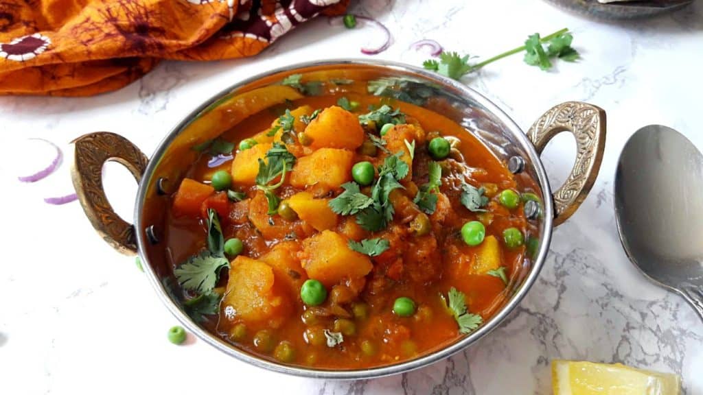 Aloo Matar in Copper Pot on Marble top