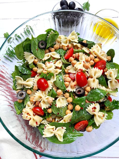 Bow Tie Pasta, Spinach, olives and tomatoes, chickpeas marinated in lemony greek vinaigrette