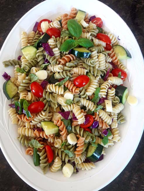 Italian Pasta Salad served cold to brighten your summer gatherings. Cooked pasta, rainbow veggies , marinated cheese make this delicious and easy side dish created by ProfusionCurry