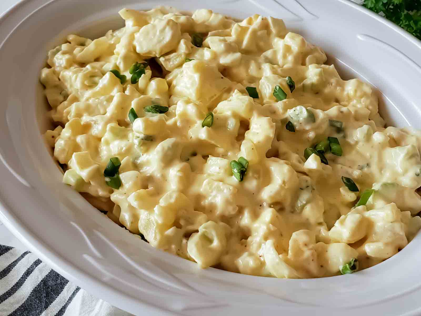 Showing hearty creamy texture of potato salad made with potatoes, and eggs in mayonnaise based cream sauce. 