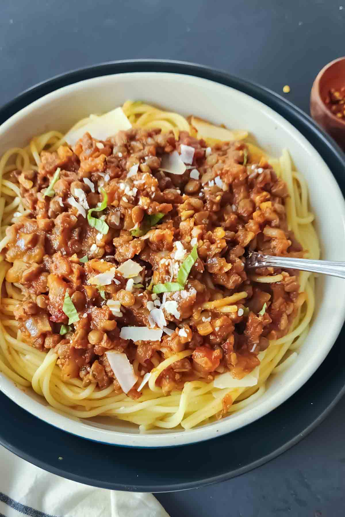Lentil Bolognese with spaghetti served with fresh basil.