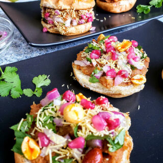 Home made dabeli garnished with cilantro, sev and peanuts. This popular Indian street food is spicy, tangy and famous party appetizer.