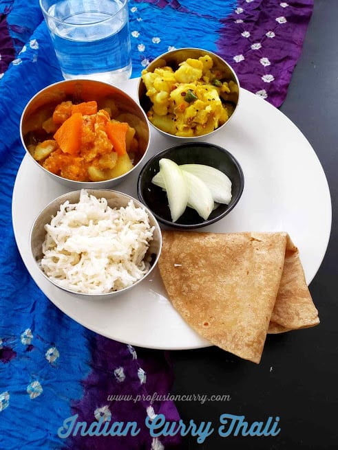 Indian curry platter with rice, roti , cut onions , pumpkin curry and potato dry curry. This scrumptious meal can me whipped under 30 minutes using Instantpot.