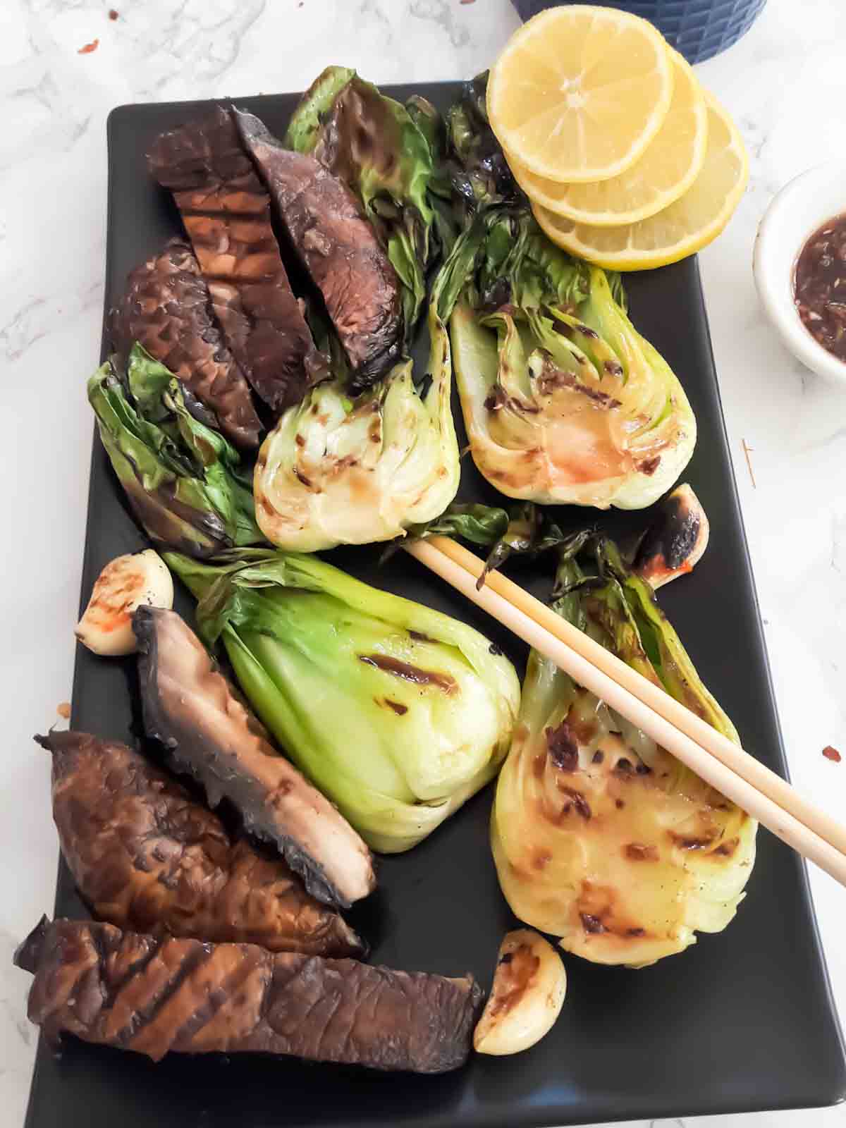 A serving platter full of Asian grilled vegetables served as a vegan and gluten free side dish.