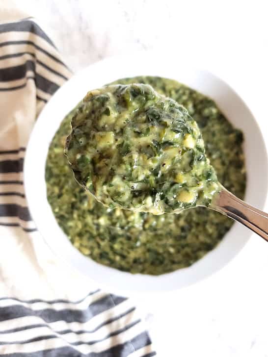 Creamed Spinach scoop showing the creamy velvety texture. 