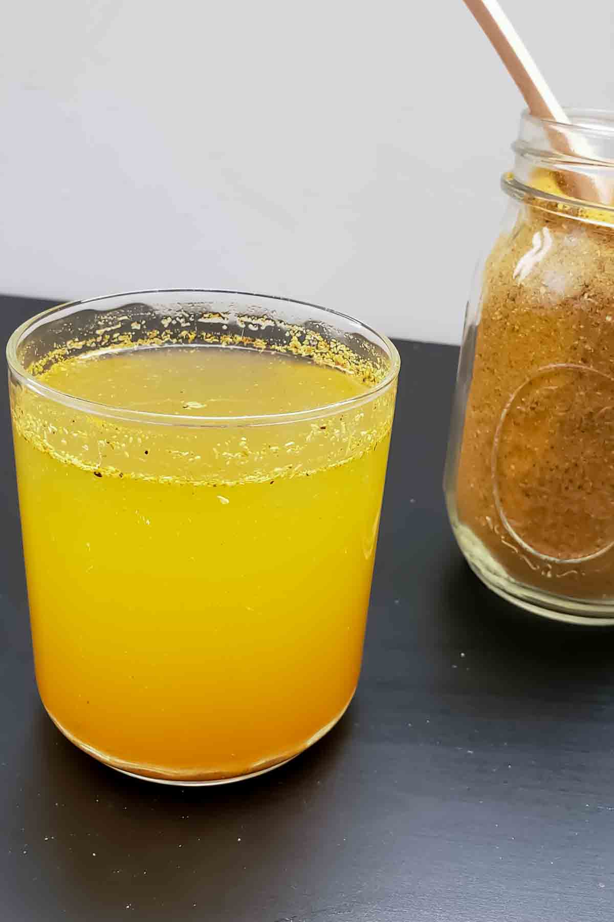 Homemade turmeric ginger tea with cinnamon, cardamom, and cloves.