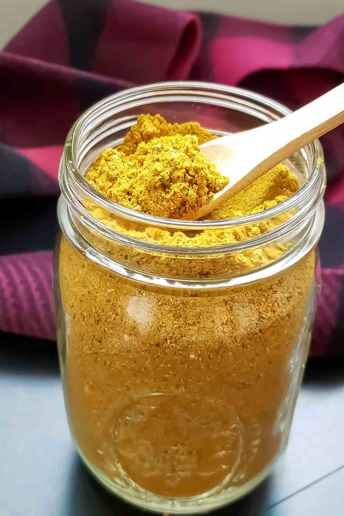 A jar of homemade spiced herbal tea mix.