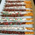 These easy Chocolate Dipped Pretzels are the perfect no-bake Christmas treat! Make these chocolate covered pretzel rods for holiday parties, Christmas dessert trays, cookie exchanges, or homemade edible gifts.