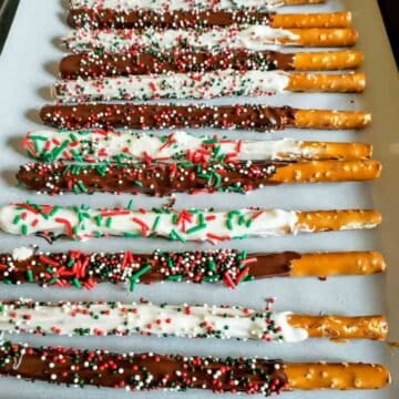 These easy Chocolate Dipped Pretzels are the perfect no-bake Christmas treat! Make these chocolate covered pretzel rods for holiday parties, Christmas dessert trays, cookie exchanges, or homemade edible gifts.
