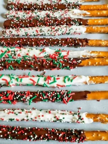 These easy Chocolate Dipped Pretzels are the perfect no-bake Christmas treat! Make these chocolate covered pretzel rods for holiday parties, Christmas dessert trays, cookie exchanges, or homemade edible gifts.