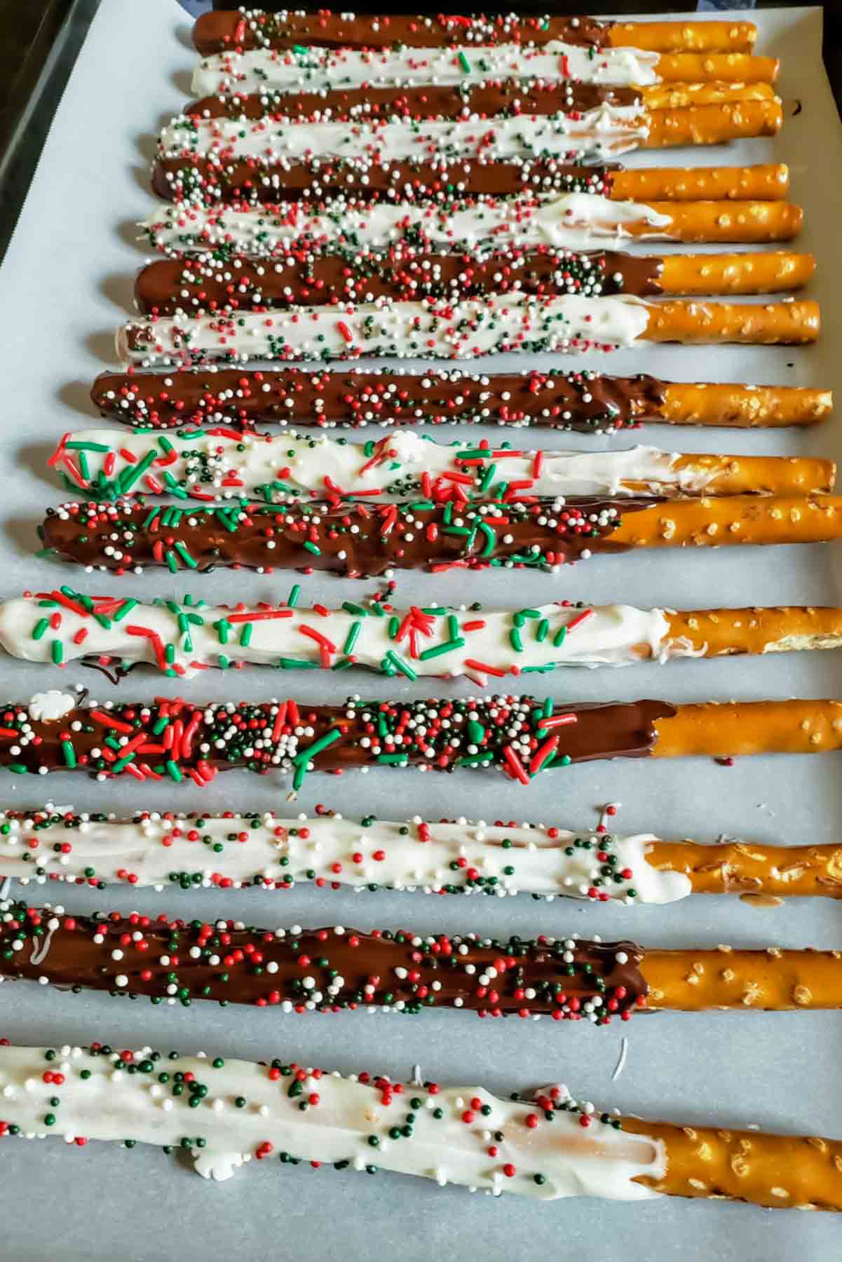 Easy chocolate covered pretzels made with pretzel rods and holiday sprinkles.
