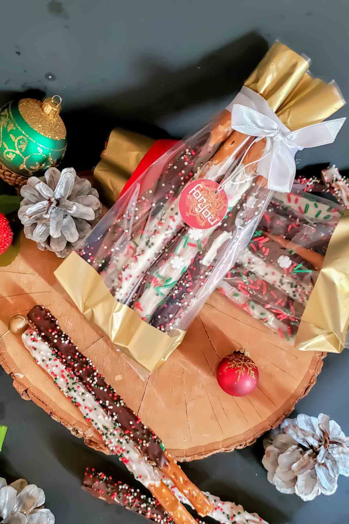 Homemade chocolate dipped pretzels for holiday gifts.