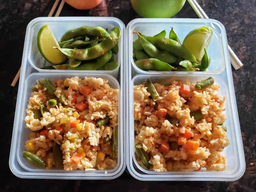 Vegetable fried rice packed like a bento box lunch along with Chili Garlic Edamame.