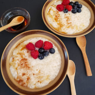 Classic custard like Tapioca pudding served in two bowls with maple and cinnamon drizzle and fresh berries. This profusioncurry recipe is vegan and gluten free and eggless.