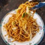 Lo Mein Noodles getting served in a bowl.