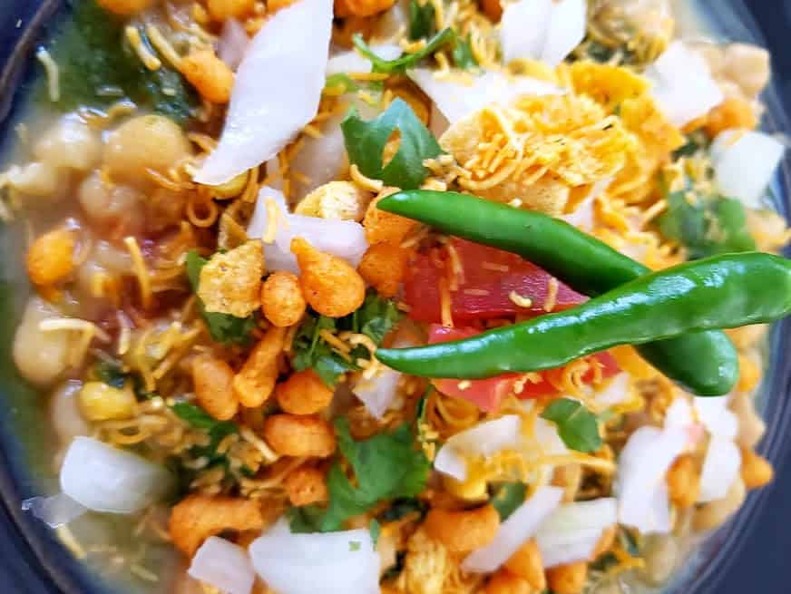 Close up photo displaying different layers and textures of Matar Chaat.