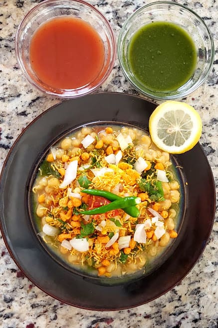 Matar Chaat served with lemon wedges and two chutney bowls on side. This profusioncurry creation is popular Indian street food recipe.