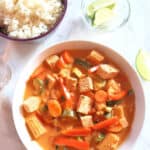 Chunks of assorted vegetables and tofu dunked in Thai red curry served with cooked Jasmine rice on the side and lime wedges. This classic curry is profusioncurry recipe.
