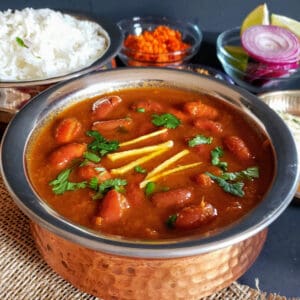 Red Kidney Beans curry served in copper container with white rice .