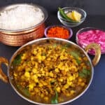 Pinterest image of Sprouts Curry recipe. This delicious Indian curry pairs well with steamed rice, raita and pickle.