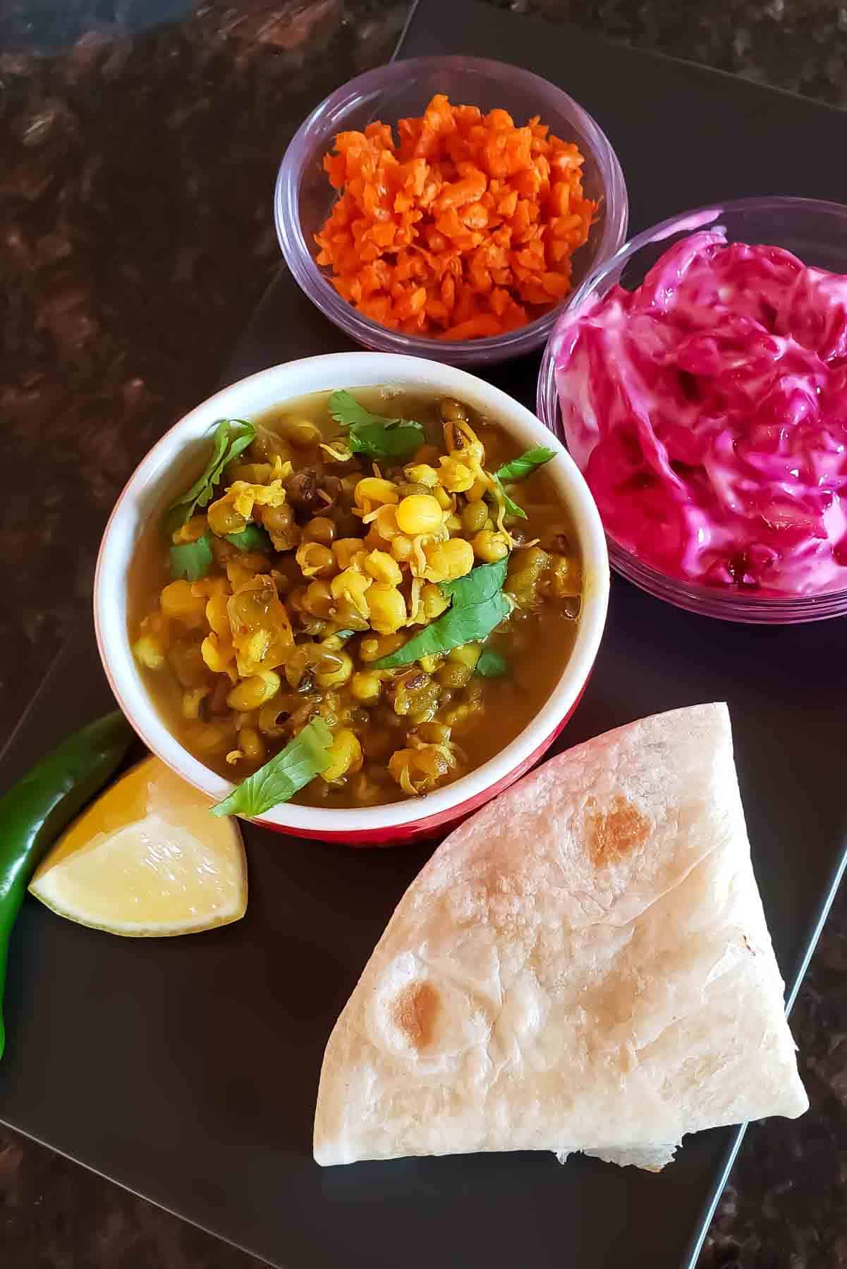Vegan Indian sprouts curry served with steamed basmati rice and pickles.