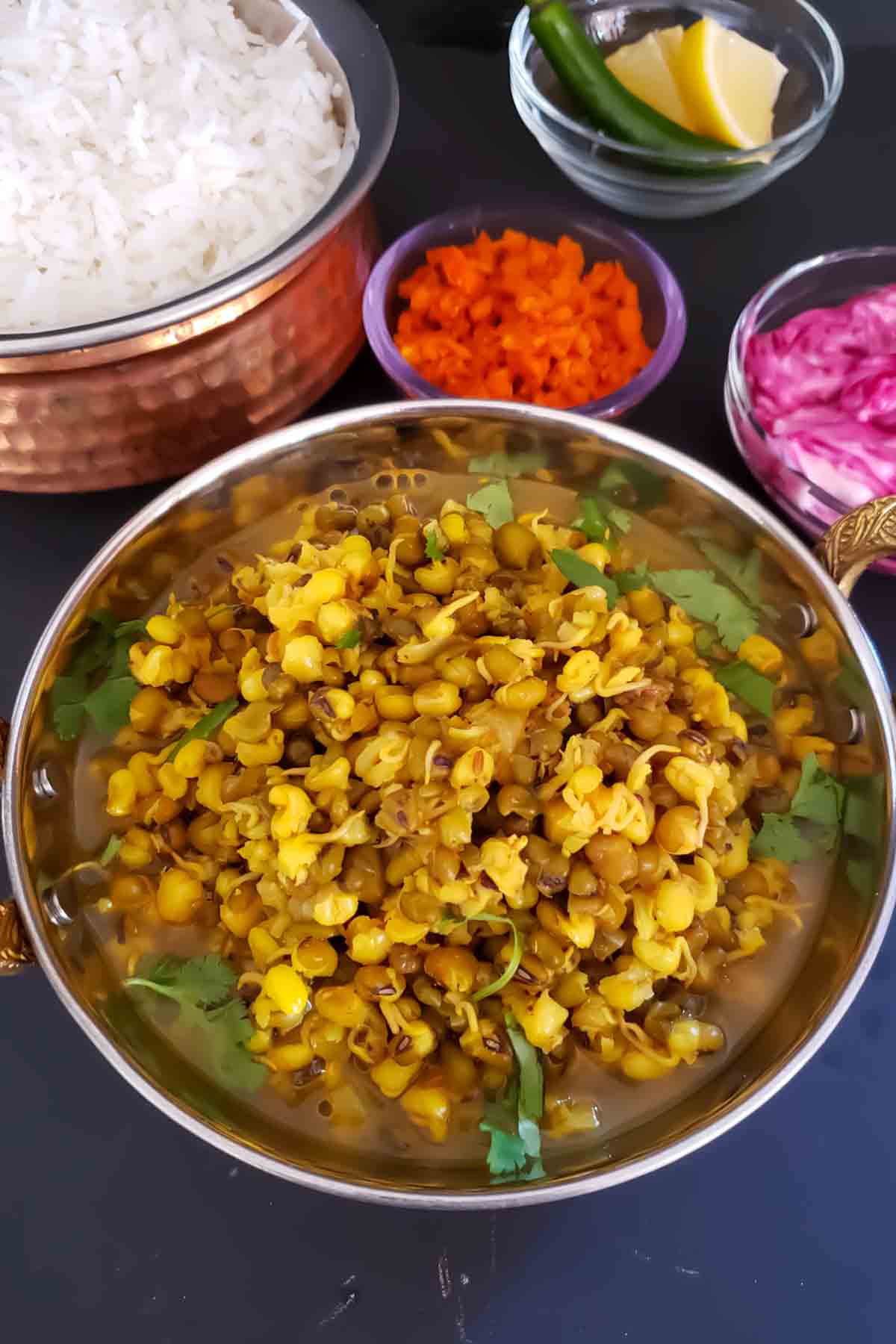 Protein-rich green moong sprouts curry made with tomatoes and Indian spices.
