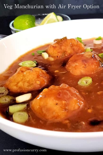 Air fried veg dumplings dunked in savory spicy Manchurian sauce to make popular Indo Chinese Veg Manchurian Recipe. This low calorie Profusioncurry recipe is perfect for party appetizer.