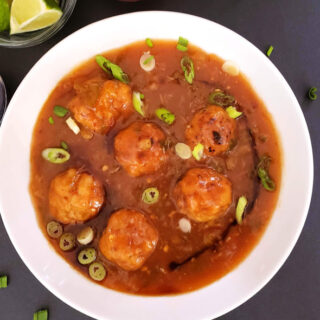 Veggie filled dumplings tossed in delicious manchurian sauce. This popular Indo Chinese street food recipe is tweaked to make low calorie and figure friendly.