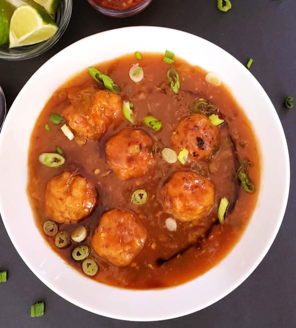 Veggie filled dumplings tossed in delicious manchurian sauce. This popular Indo Chinese street food recipe is tweaked to make low calorie and figure friendly.