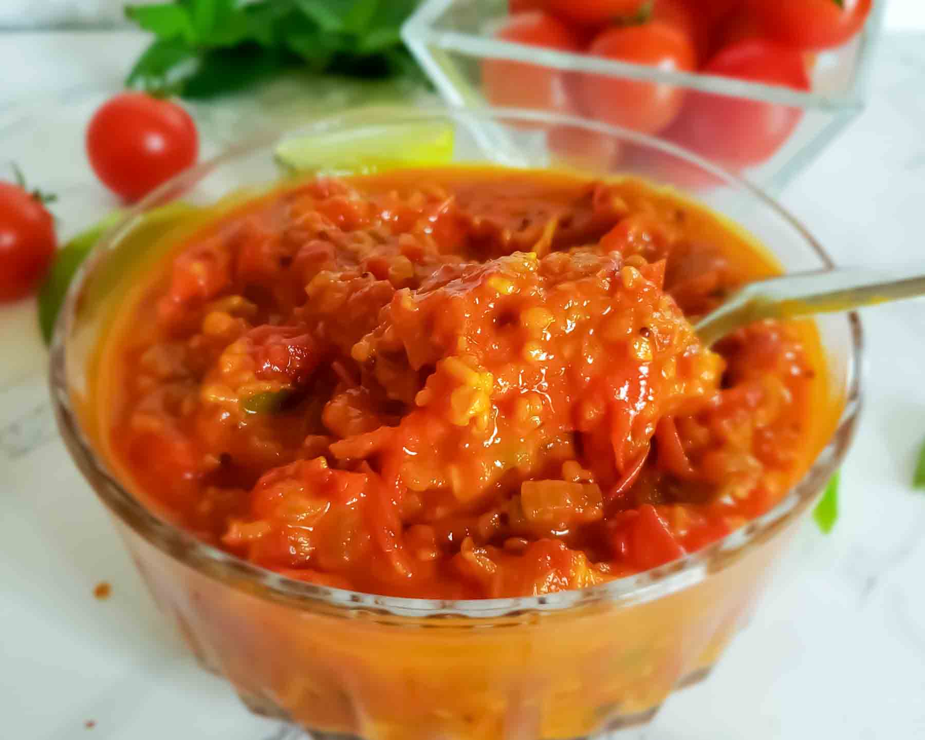 Close up image showing thickly reduced sweet and spicy tomato chutney made with cherry tomatoes. 